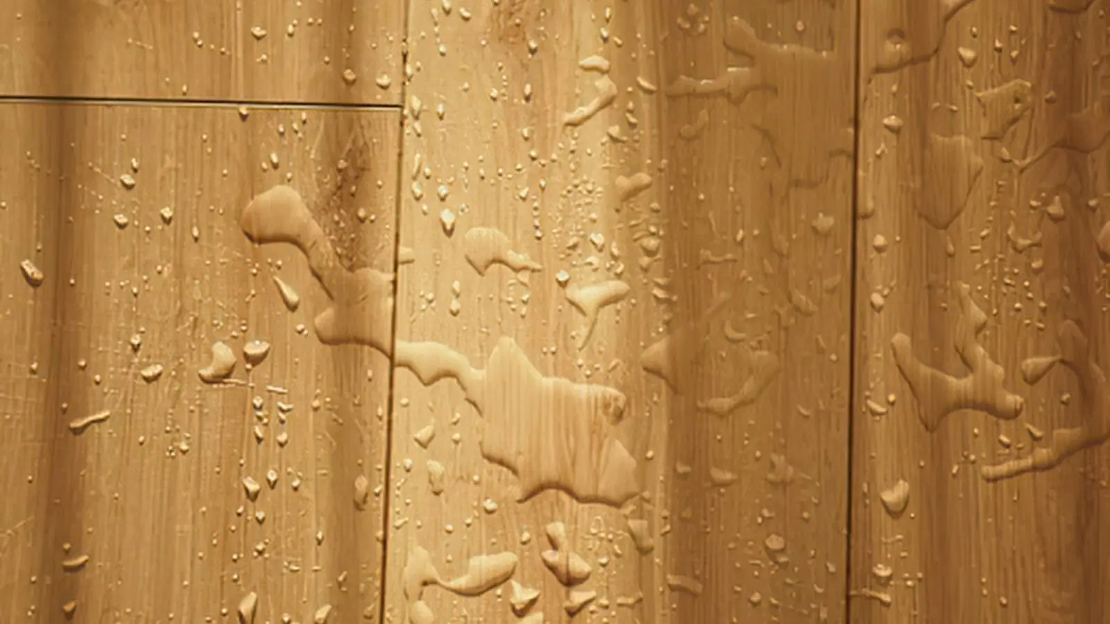 Water droplets beading on wood floor planks